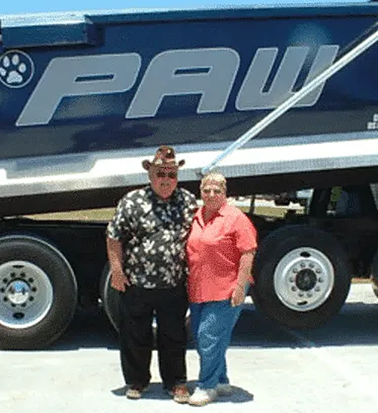The Wohlfiel family, founders of PAW Companies, in front of a PAW truck